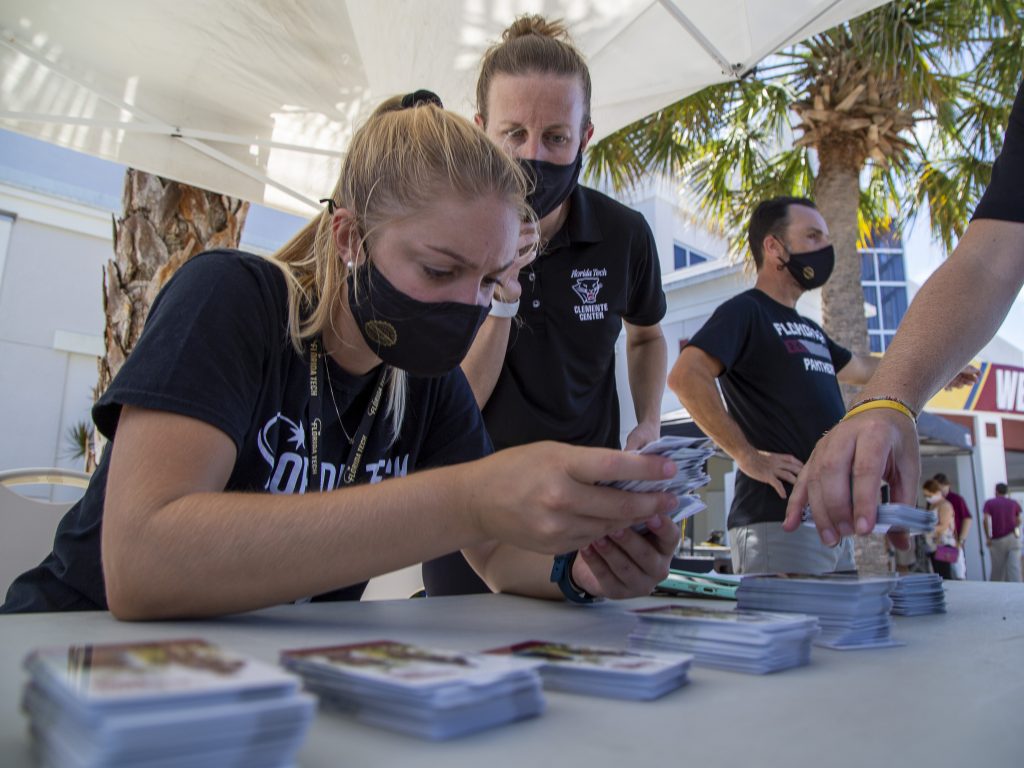 Volunteers look for for the correct ID cards for students during Florida Tech's student check-in.