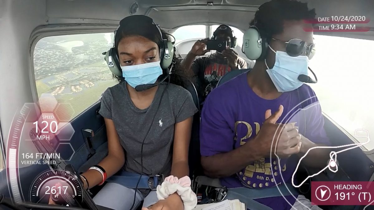 Navi Tillman, 16, takes the yoke beside Ramone Hemphill, founder of the 99th Squadron, a nonprofit that teaches young people the fundamentals of aviation.