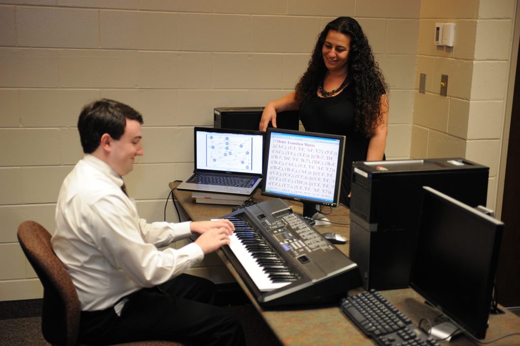 Dr. Munevver "Mine" Subasi works with a student on his senior design project.