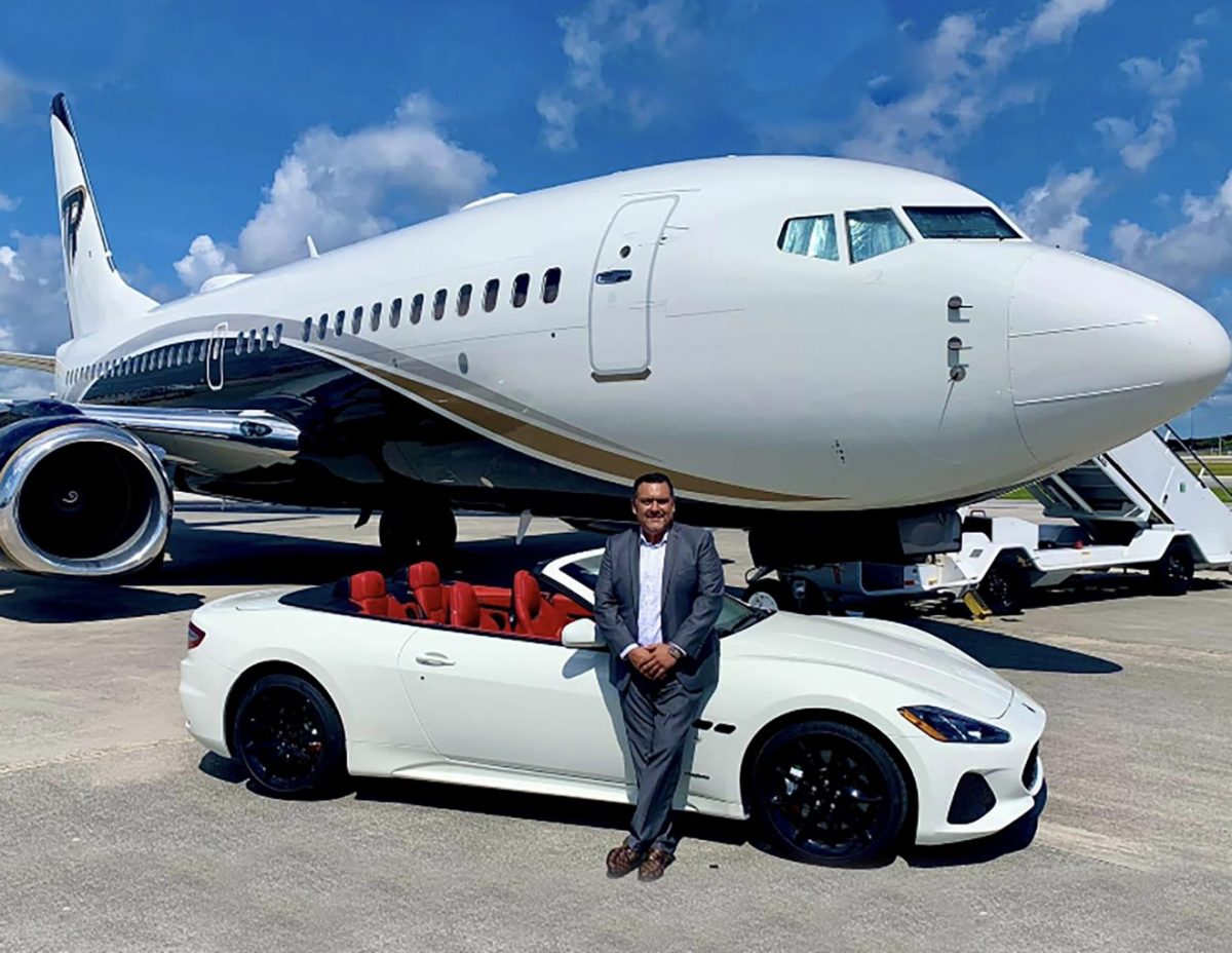 Man standing next to car and vehicle.