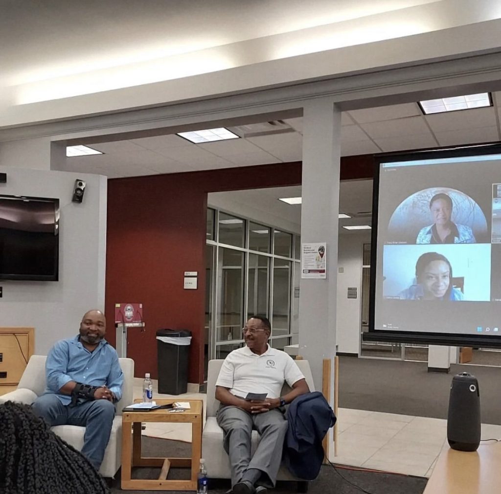 Two people sitting and listening.