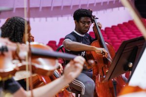 Male student playing the cello
