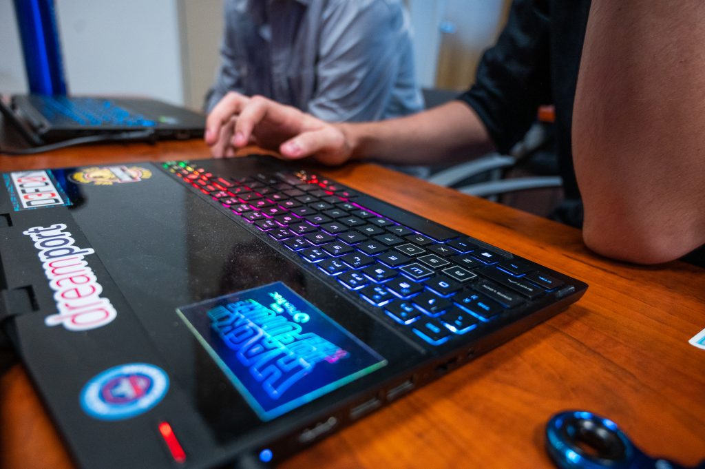 Laptop with an illuminated keyboard and "Hack to the Future" sticker