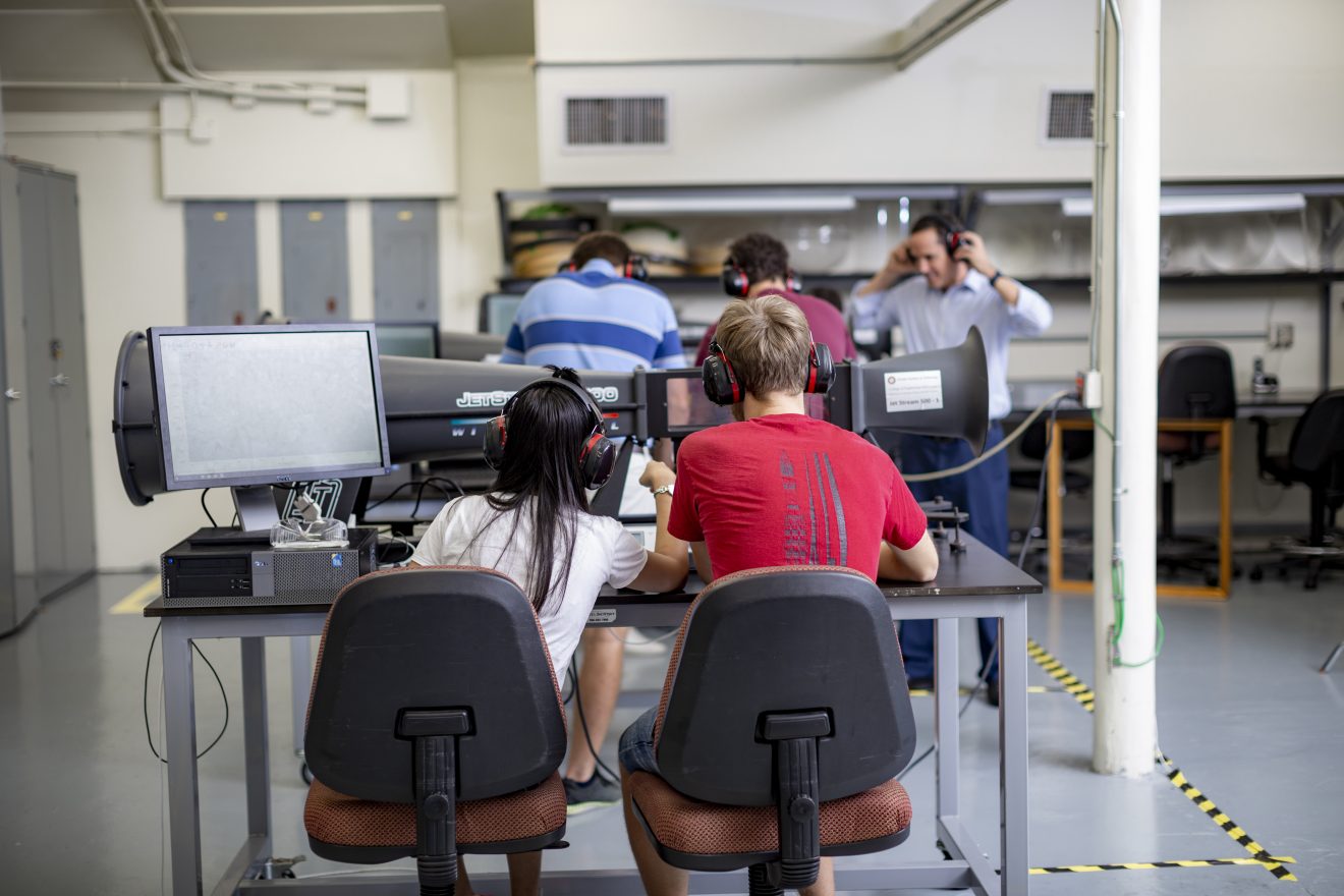 Students working at an equipment testing command workstation.