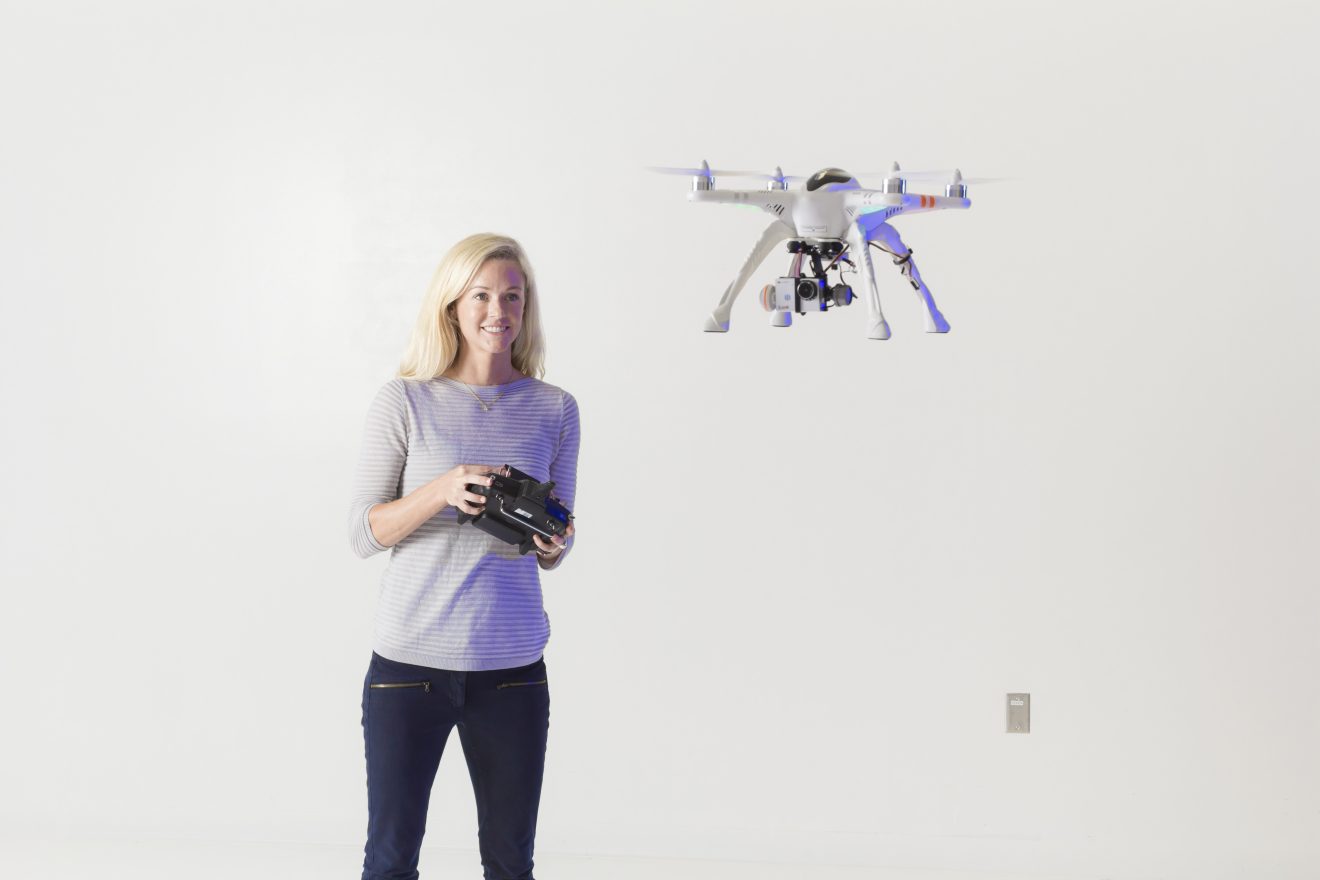 Woman flying a drone.
