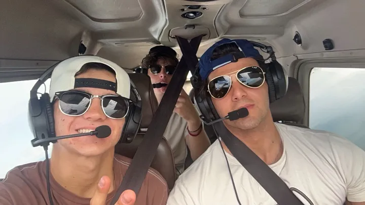 Diego and Blaise sitting in a cockpit.